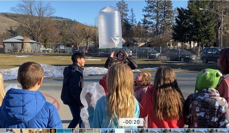 students launching an inflatable science project 