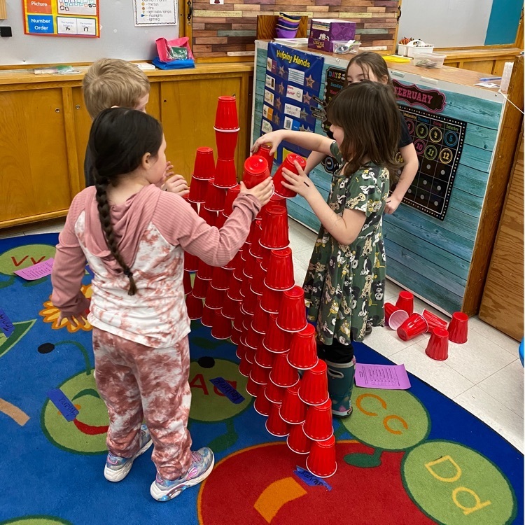 students stacking 100 red cups