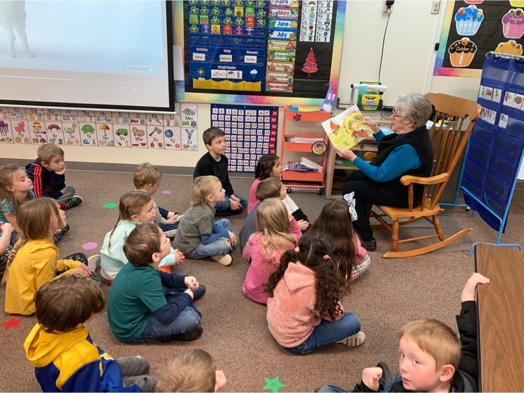 A volunteer reads a story to the students.