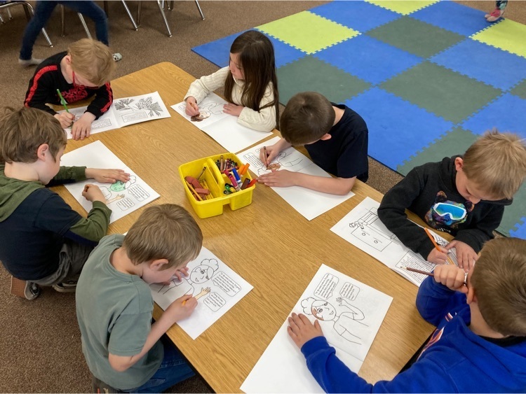 Students coloring the “From Seed to Seat” book.
